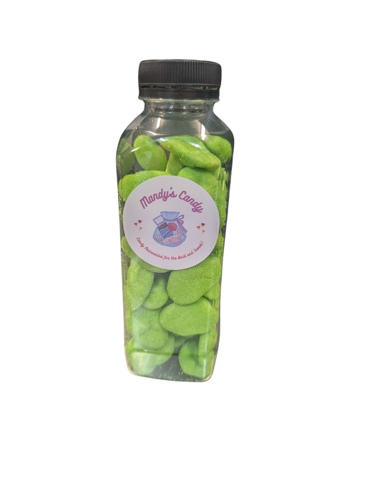 Clear bottle filled with green candy and a label on a white background